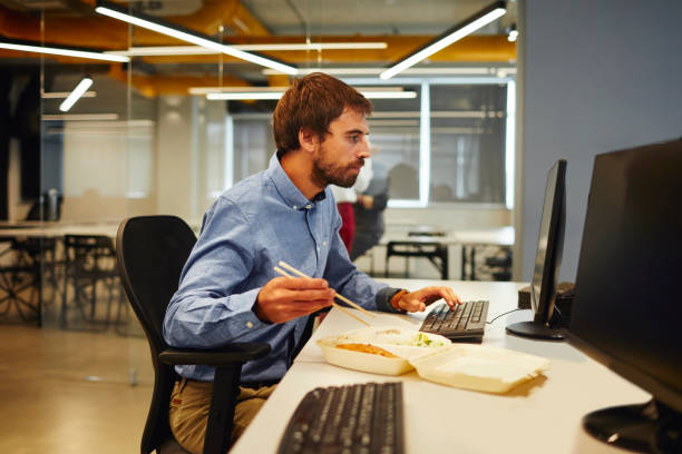 istock Businessman Eating in His Office 1054082694