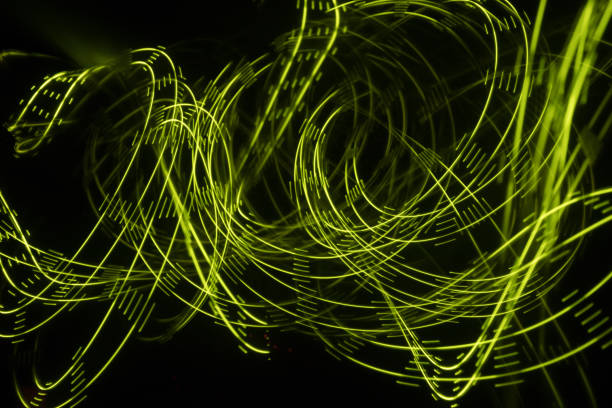 istock Overlaying wavy lines forming an abstract pattern on a dark background. Long exposure light background. 1054084510