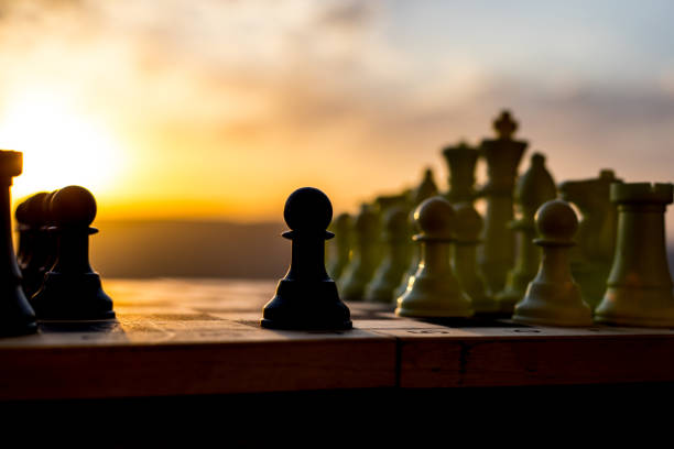 istock chess board game concept of business ideas and competition and strategy ideas. Chess figures on a chessboard outdoor sunset background. 1054084538