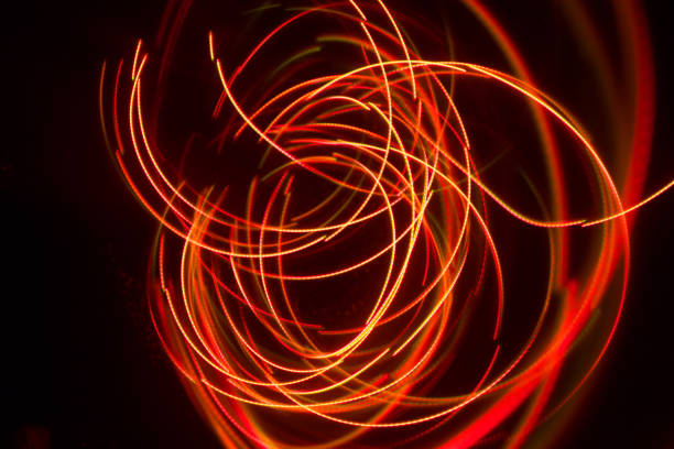istock Overlaying wavy lines forming an abstract pattern on a dark background. Long exposure light background. 1054084542