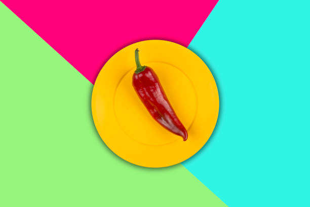 Fresh Red Pepper in yellow plastic Plate on multicolored pop art Background .Vitamins Healthy Diet Spring Summer Detox Vegan. Ready to write.Poster Banner Template.