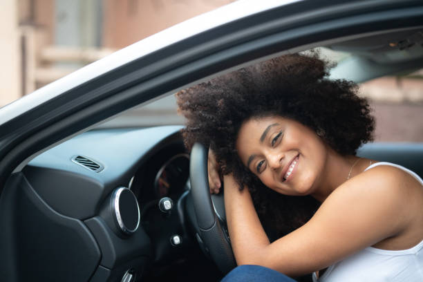 Woman Driver Portrait at Car Interior - Pride My First Car car insurance photos stock pictures, royalty-free photos & images