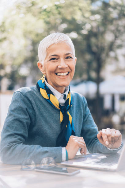 istock Mature businesswoman working at cafe 1054092758