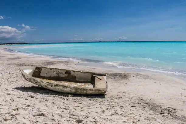 A small abandoned boat sits on a beach just outside of Florence, Italy. Look at the beautiful ocean scenery.