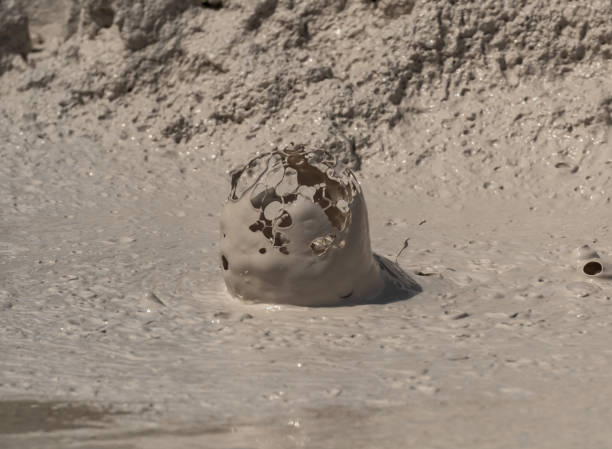 istock Bubble Bursts up from muddy paint pot 1054099170