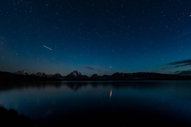 istock Airplane Light and Stars Over Jackson Lake 1054102300