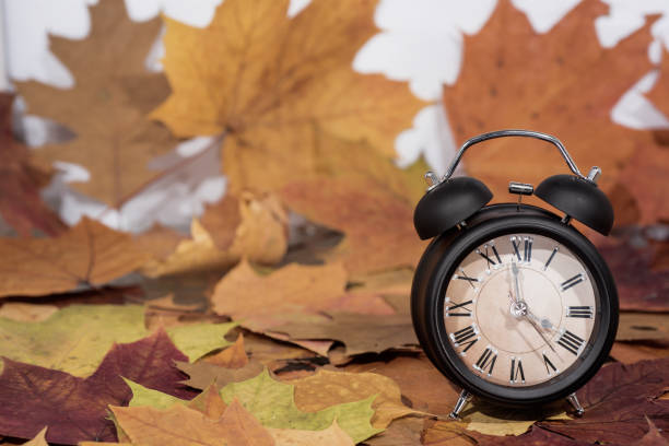 Daylight Saving Time. Wall Clock going to winter time. Autumn abstraction. Daylight Saving Time. Wall Clock going to winter time. Autumn abstraction. Fall back time. person falling backwards stock pictures, royalty-free photos & images