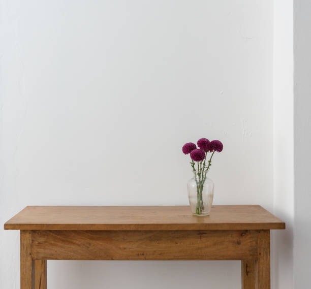 istock Purple pom pom chrysanthemums in glass vase on oak table 1054110596