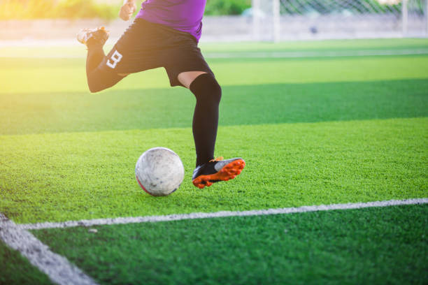 istock The kid Asian soccer player shoot ball 1054126338