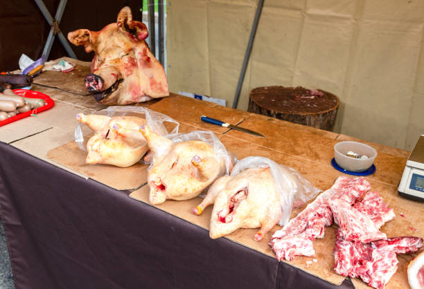 istock Poultry meat and pig head ready for sale 1054140962
