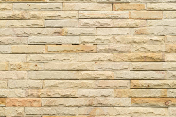 istock Beautiful yellow stone wall background 1054142478