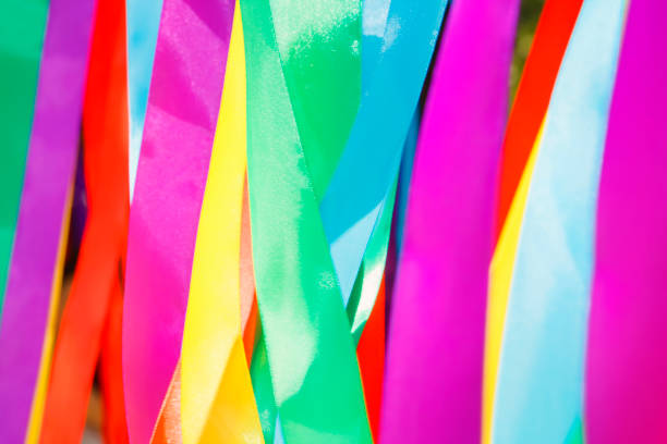 Multicolored silk ribbons are heard in the wind. Background image. Soft focus
