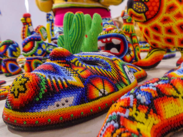 A mask completely made of wood and jackets representative of Mexican culture.