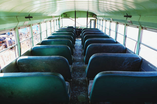 Abandoned School Bus Wide view of the interior of an abandoned school bus. empty school bus stock pictures, royalty-free photos & images