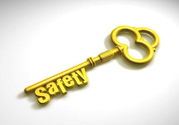 horizontal closeup of pair of keys in old metallic golden door lock with selective focus