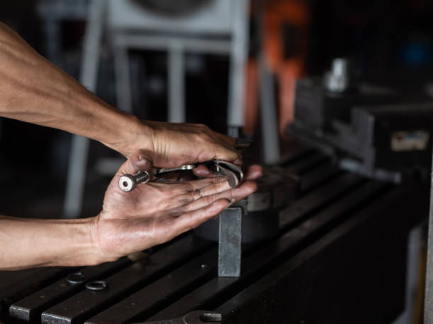 Men's hands with locking pliers Working on Lathe machine. metalworking industry concept.