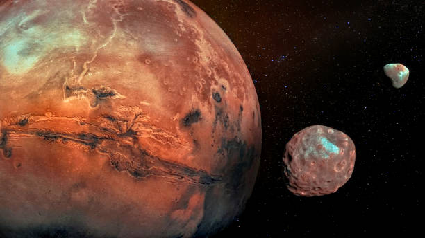 Mars with its two cratered moons Phobos and Deimos. Elements of this image furnished by NASA. stock photo