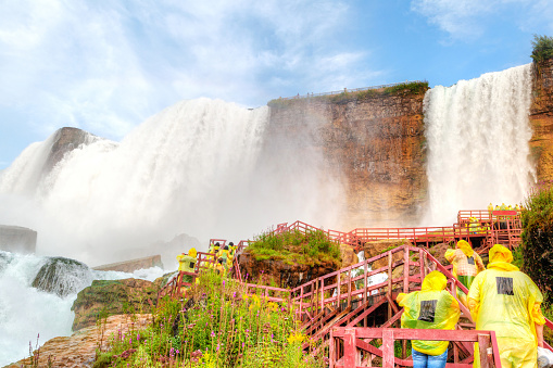 Niagara Falls, Canada - August 14, 2022: People having fun on a tourboat at the Niagara Falls in Canada