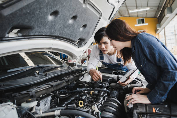 istock Reliable auto mechanic talking to a female customer the engine error in a modern automobile repair shop 1054183598