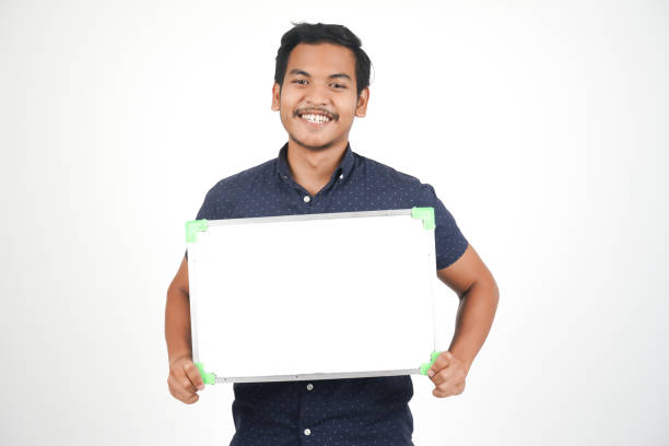 istock Isolated Young Asian Man With Whiteboard 1054184302