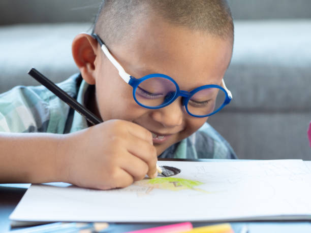 istock Boy intend drawing a picture fun, enjoy drawing or write in book at home. 1054195172