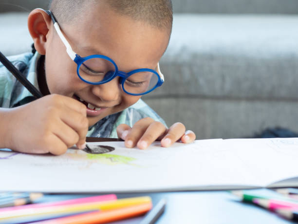 istock Boy intend drawing a picture fun, enjoy drawing or write in book at home. 1054195178