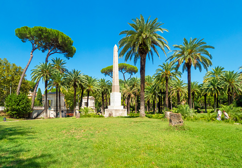 Rome, Italy - 19 August 2018 - The Villa Torlonia, public park of Rome with fountains, neoclassical palaces, museum and surrounding gardens, formerly belonging to the Torlonia family. Here in particular a building of park.