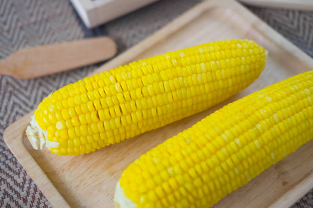 istock Boiled sweet corn served on wooden tray 1054201558