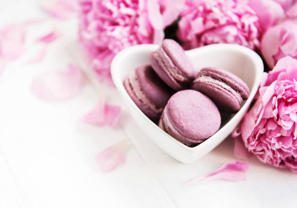 istock Pink peony flowers with macarons 1054213210