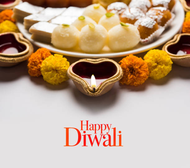 istock Happy Diwali Greeting Card made using sweets, or fire crackers or Diya or flowers, selective focus 1054221648