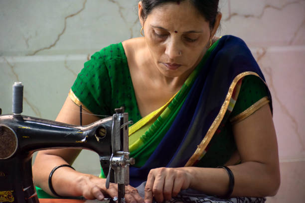 indian women  stitching cloths by machine at home - sewing tailor sewing machine women imagens e fotografias de stock