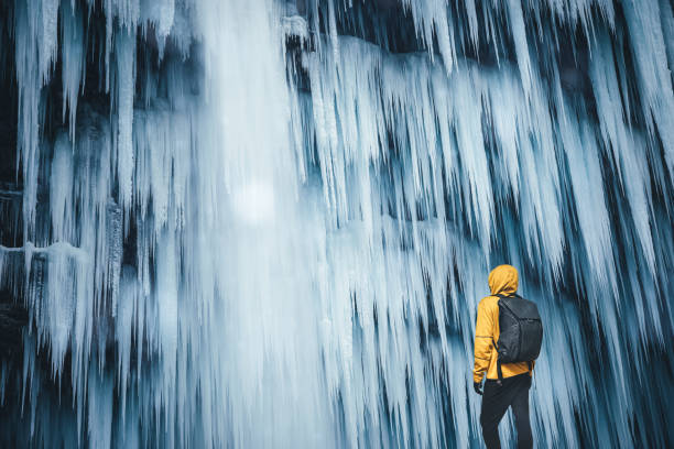 istock By The Frozen Waterfall 1054241598