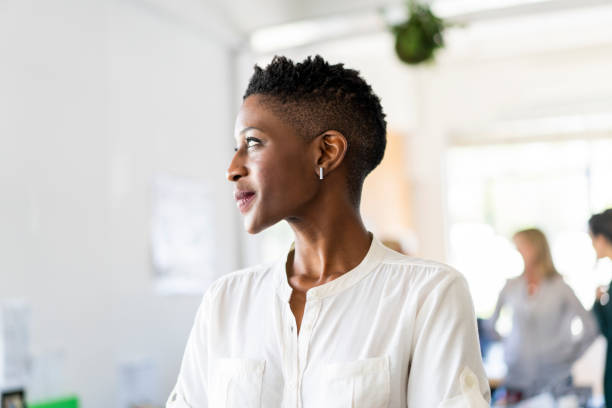Businesswoman day dreaming at creative office