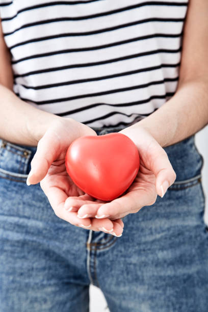 istock Hand holding the heart symbol with love 1054244040