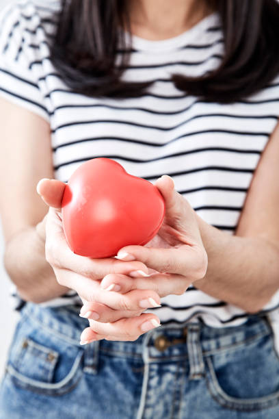 istock Hand holding the heart symbol with love 1054244086