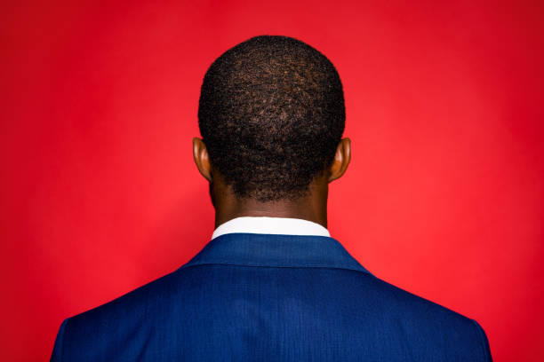 back view of young chic classy brunet sophisticated style man stand isolated on red vivid background - rear view back human head men imagens e fotografias de stock