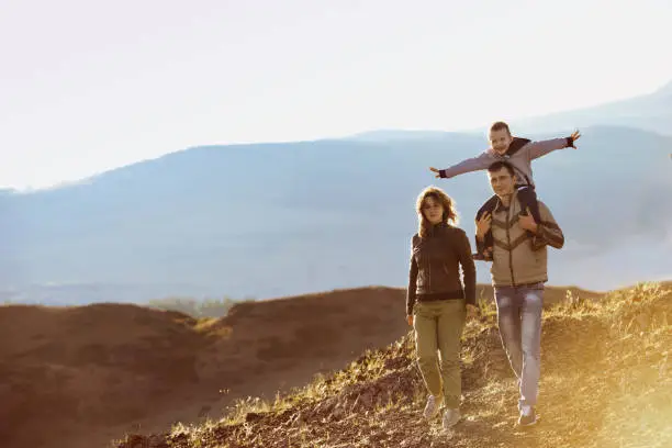 Photo of Happy family walking nature mountains area