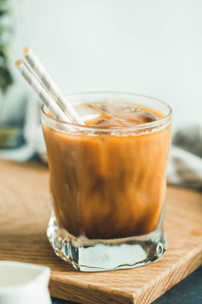 istock Refreshing iced latte in a glass with straws in a modern kitchen. 1054249984