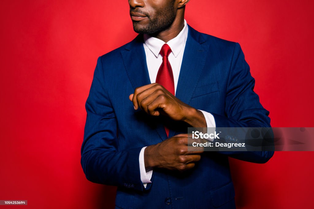 Cropped close up photo of sale manager entrepreneur chic employee employer occupation leadership gentleman groomed man correct cufflink fasten clasp on wrist isolated on red bright background Men Stock Photo