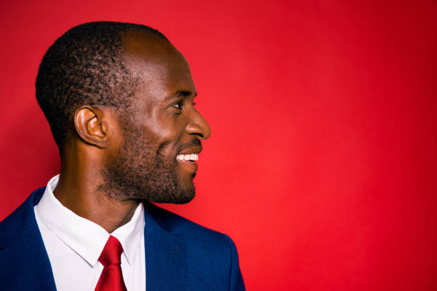 istock Profile side view portrait of cheerful optimistic positive handsome man with white teeth in suit isolated over bright vivid red background copy empty blank space placr 1054255786