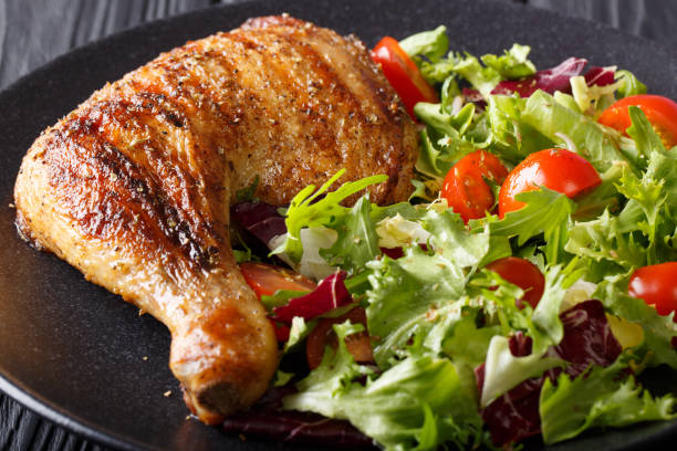 istock grilled chicken leg with fresh vegetable salad close-up. horizontal 1054256378