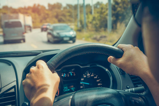 istock Human's hand holding steering wheel tight. Vintage effect tone. 1054258542
