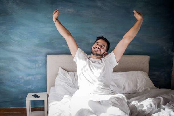 It's time to wake up the man is going to bed in the morning with a smile on his face waking up photos stock pictures, royalty-free photos & images