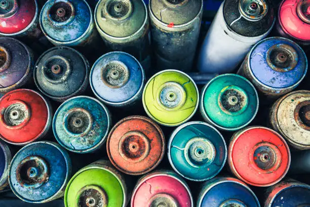 Spray cans photographed from above, you see all the colors usable.