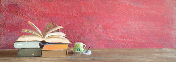 istock Old books and a coffee cup, grunge background, good copy space 1054296070