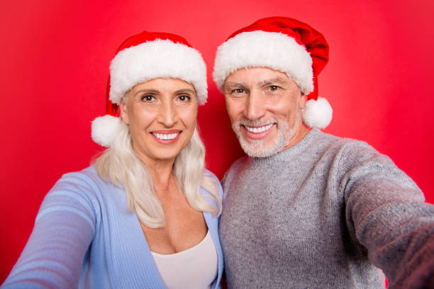 istock Self-portrait of two nice cheerful positive optimistic glad grey-haired married spouses husband wife spending time leisure isolated over red pink background 1054300046