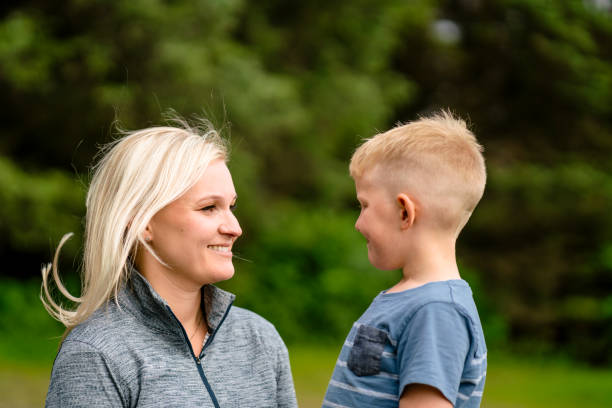 istock Smiling mother and son face to face at park 1054302210
