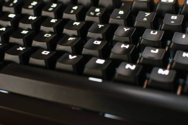 istock Mechanical gaming keyboard close up letters, white backlit 1054306184