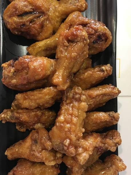 istock Fried chicken wings in a variety of ceramic dishes. 1054309504