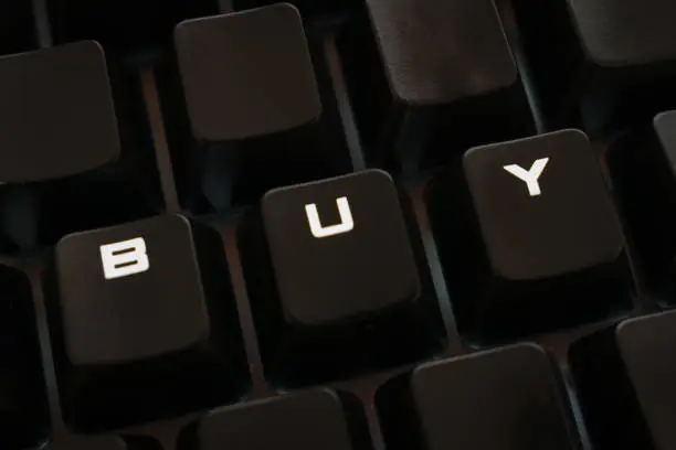 Photo of Buy word on keyboard with rearranged letters, backlit keys